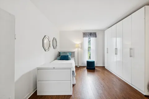 a view of a storage & utility room with closet wooden floor