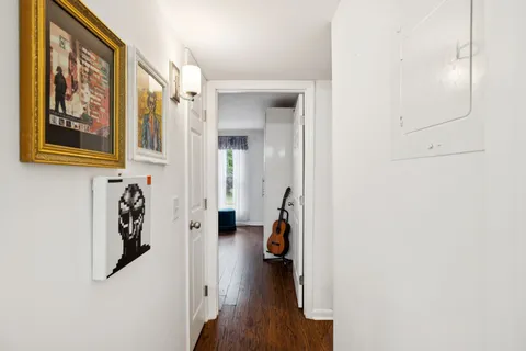 view of a hallway with wooden floor and closet
