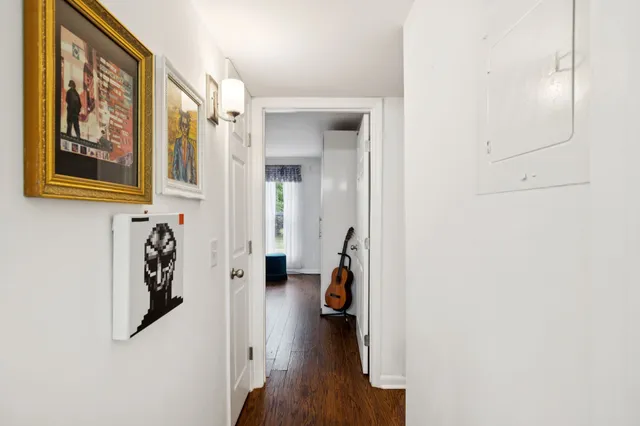 view of a hallway with wooden floor and closet