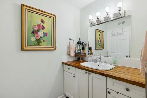 a bathroom with a double vanity sink and a mirror