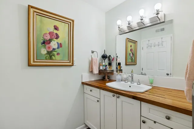 a bathroom with a double vanity sink and a mirror
