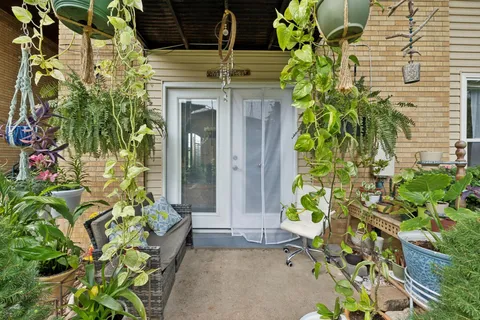 a front view of a house with a garden