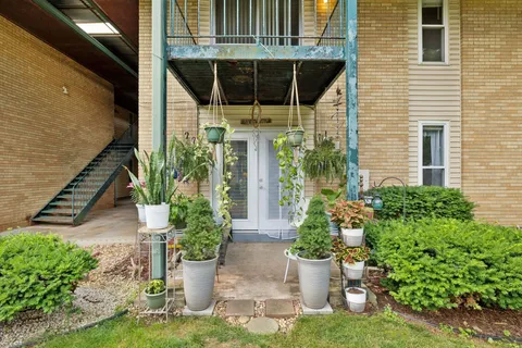 a view of a house with potted plants and a potted plant