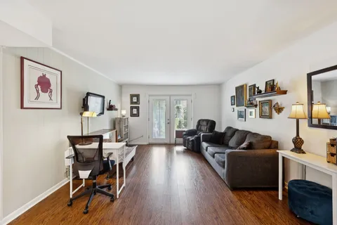 a living room with furniture and a wooden floor