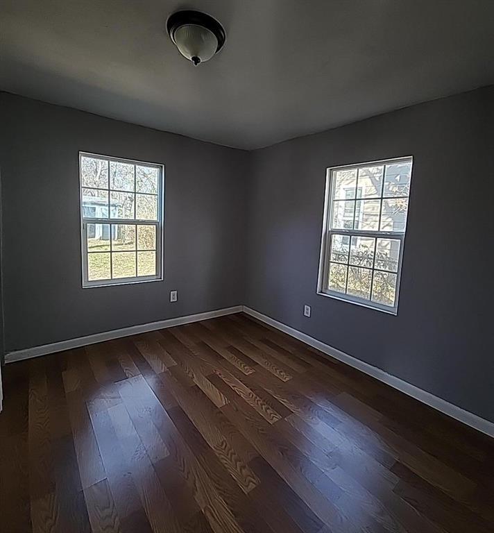 108 Monroe Street Cleburne, TX 76033 - Photo 13 of 14 an empty room with wooden floor and windows