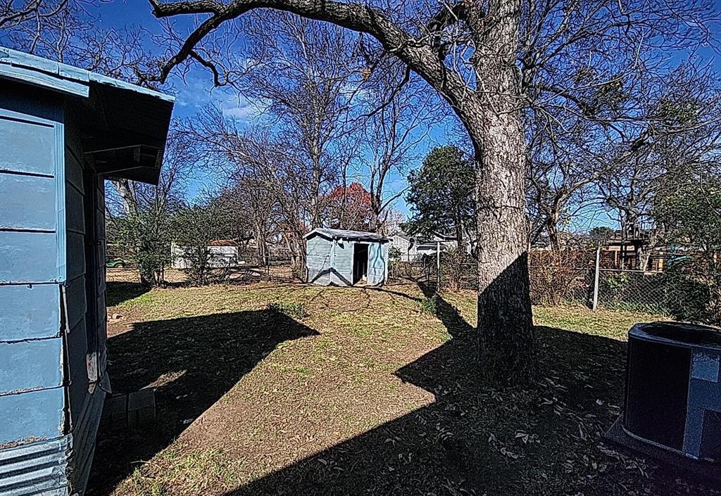 108 Monroe Street Cleburne, TX 76033 - Photo 5 of 14 a view of a yard in the back yard