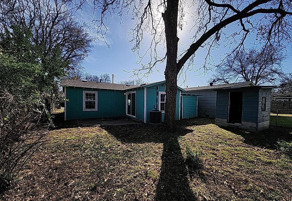 108 Monroe Street Cleburne, TX 76033 - Photo 6 of 14 a front view of a house with a yard and garage