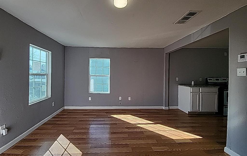 108 Monroe Street Cleburne, TX 76033 - Photo 7 of 14 a view of livingroom with window and hardwood floor