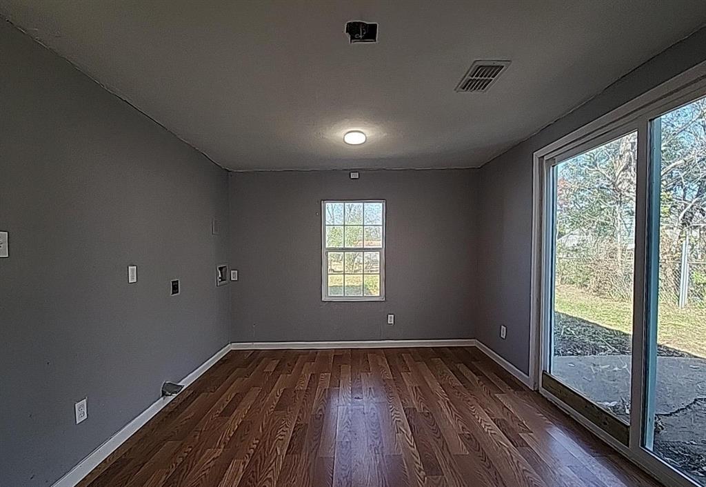 108 Monroe Street Cleburne, TX 76033 - Photo 10 of 14 a view of empty room with wooden floor and fan