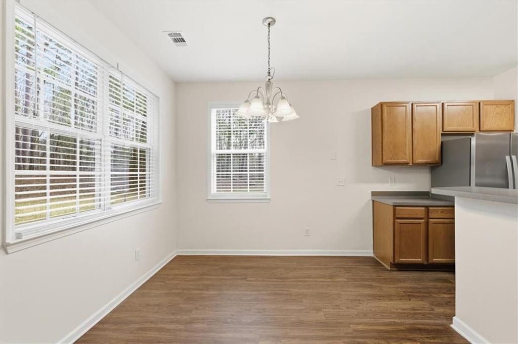 836 Topaz Valley Canton, GA 30114 - Photo 11 of 33 a view of a kitchen with a dishwasher cabinets and a wooden floor