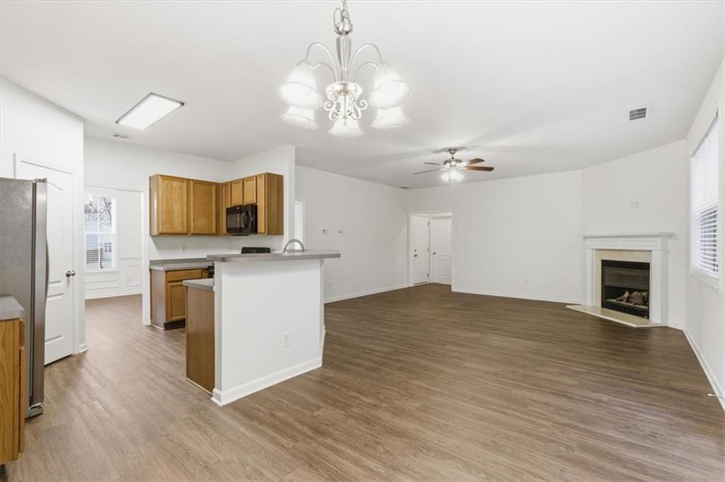 836 Topaz Valley Canton, GA 30114 - Photo 12 of 33 a view of kitchen with granite countertop cabinets stainless steel appliances and a fireplace