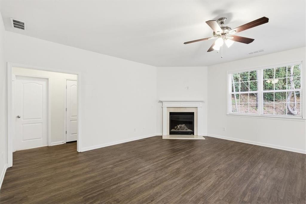836 Topaz Valley Canton, GA 30114 - Photo 13 of 33 wooden floor in an empty room with a window