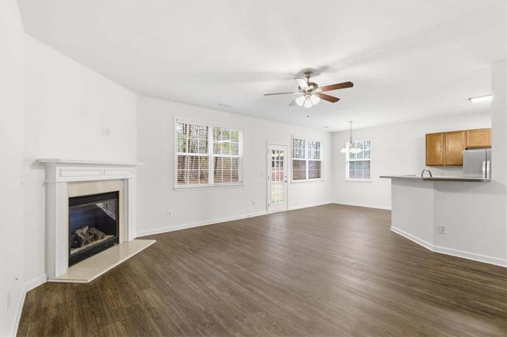 836 Topaz Valley Canton, GA 30114 - Photo 14 of 33 a view of an empty room with window and wooden floor
