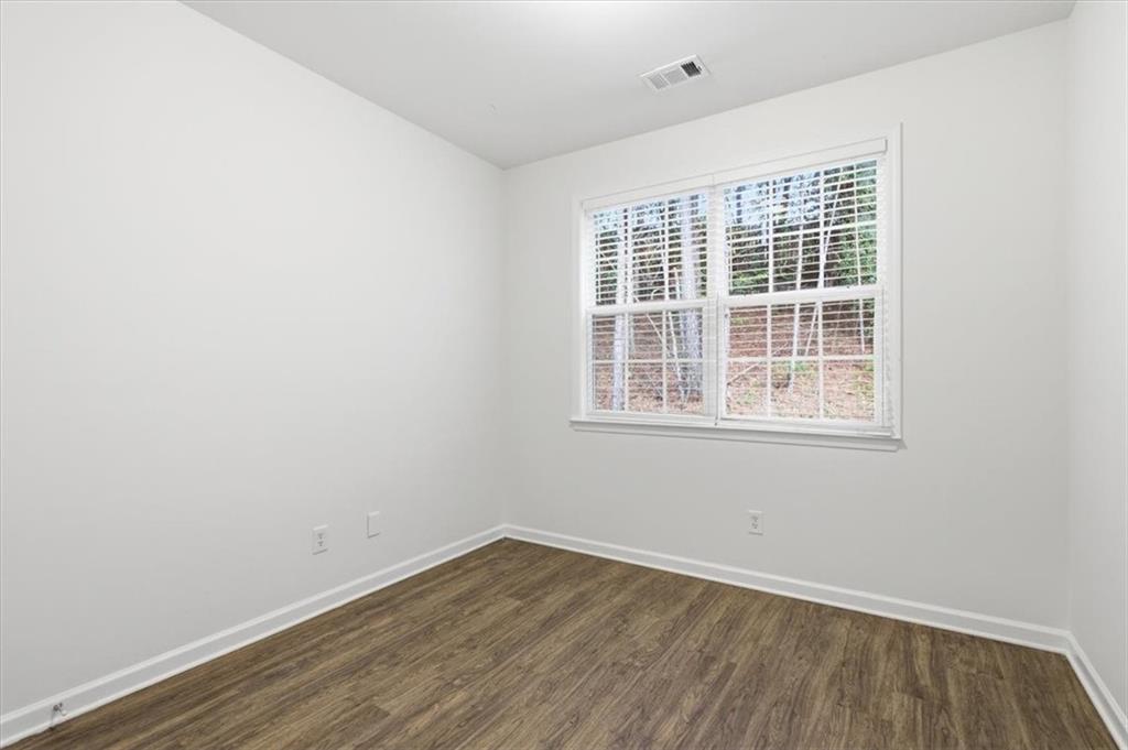 836 Topaz Valley Canton, GA 30114 - Photo 15 of 33 an empty room with wooden floor and windows