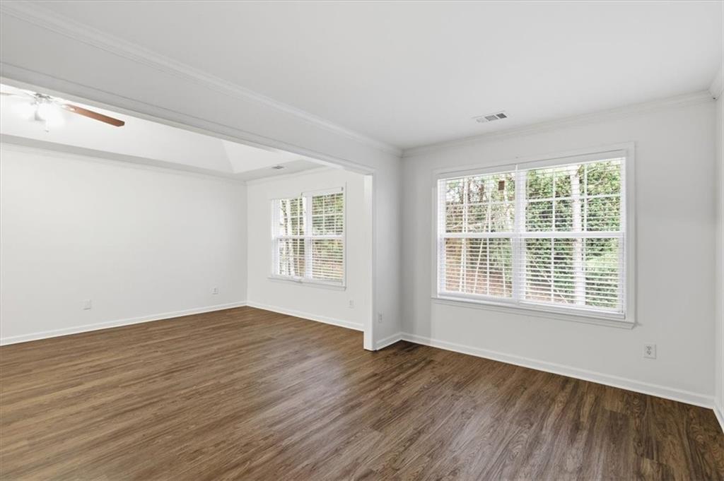 836 Topaz Valley Canton, GA 30114 - Photo 18 of 33 a view of an empty room with wooden floor and a window