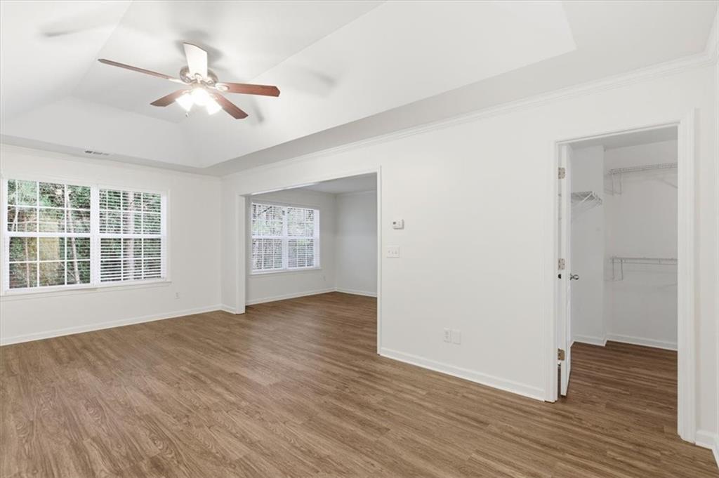 836 Topaz Valley Canton, GA 30114 - Photo 19 of 33 a view of an empty room with wooden floor and a window