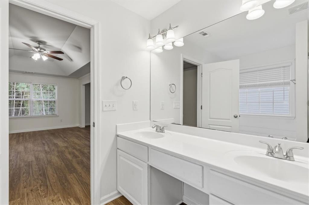 836 Topaz Valley Canton, GA 30114 - Photo 23 of 33 a bathroom with a double vanity sink and a mirror