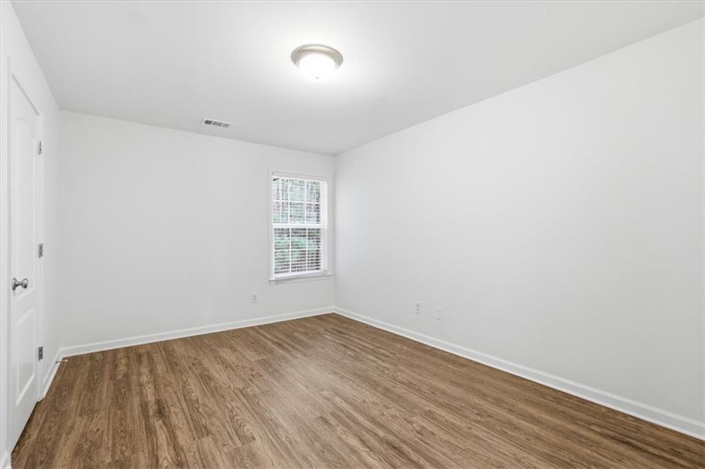 836 Topaz Valley Canton, GA 30114 - Photo 27 of 33 an empty room with wooden floor and windows