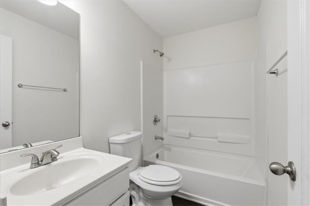 836 Topaz Valley Canton, GA 30114 - Photo 28 of 33 a bathroom with a sink a toilet and shower