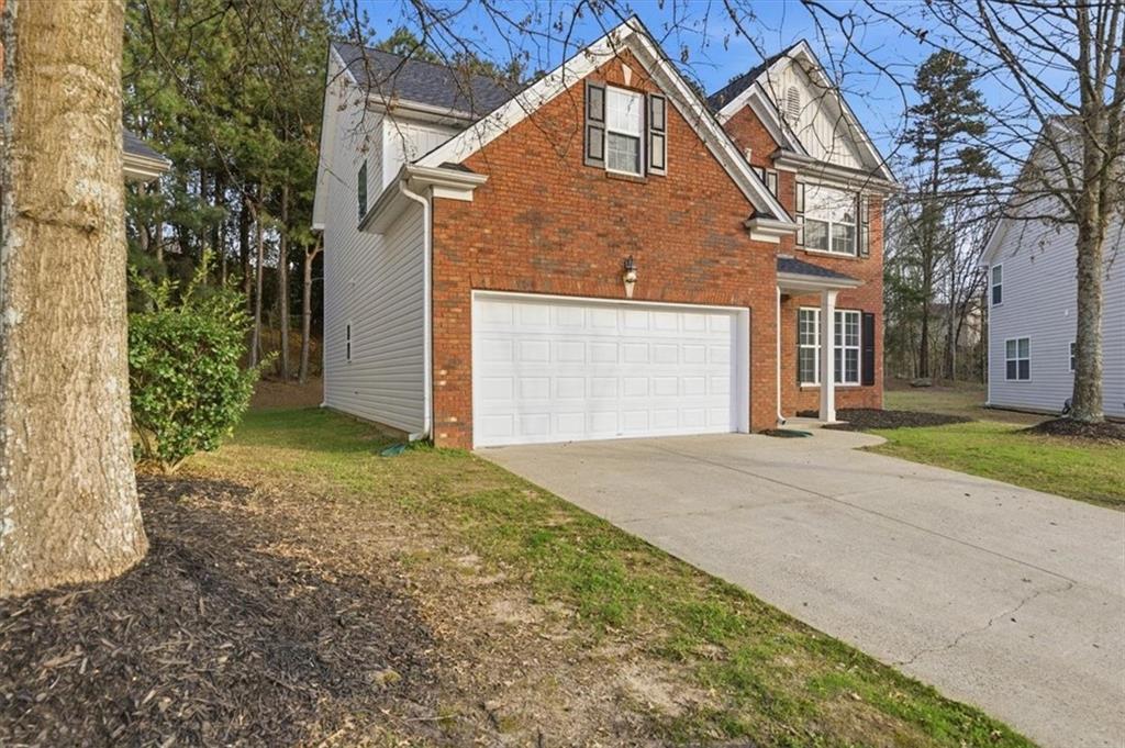 836 Topaz Valley Canton, GA 30114 - Photo 3 of 33 a view of a house with a yard and garage