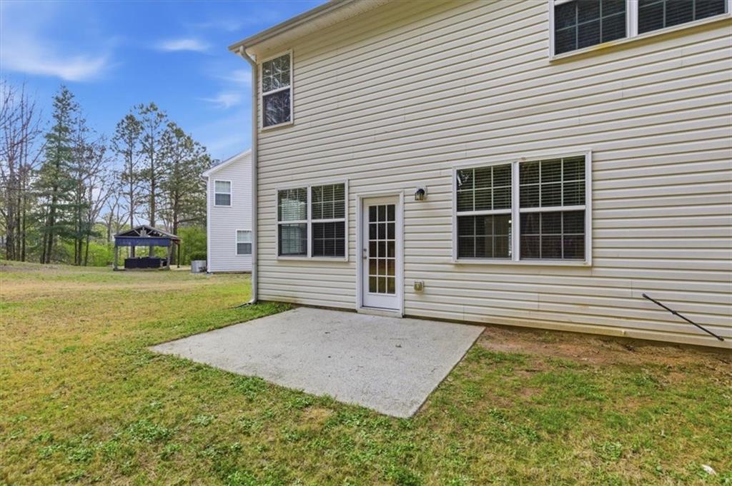 836 Topaz Valley Canton, GA 30114 - Photo 31 of 33 a front view of a house with garden