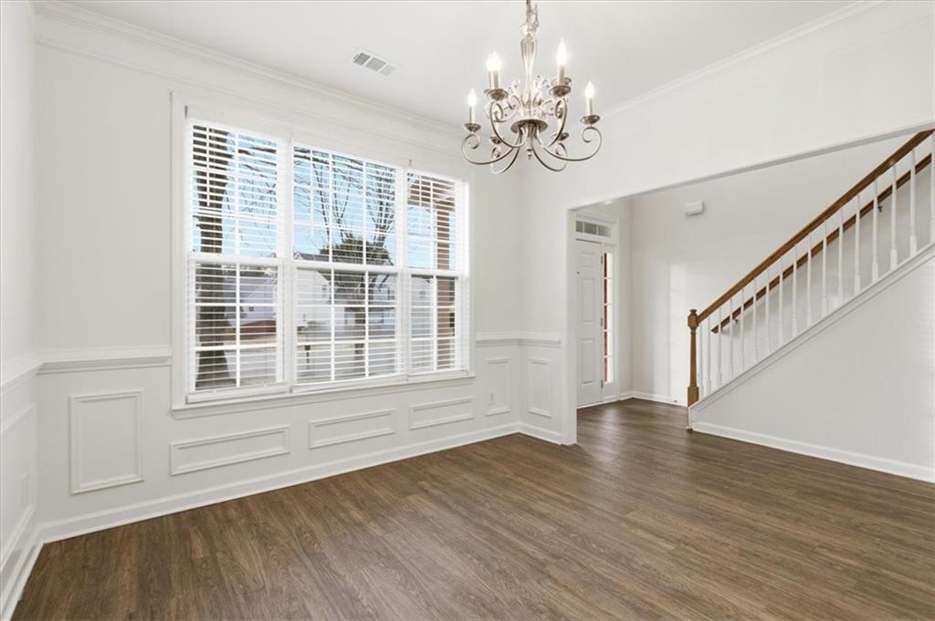 836 Topaz Valley Canton, GA 30114 - Photo 5 of 33 a view of an empty room with wooden floor and a window