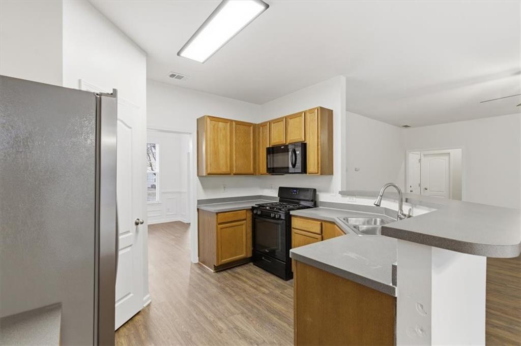 836 Topaz Valley Canton, GA 30114 - Photo 7 of 33 a kitchen with stainless steel appliances granite countertop a sink stove and refrigerator