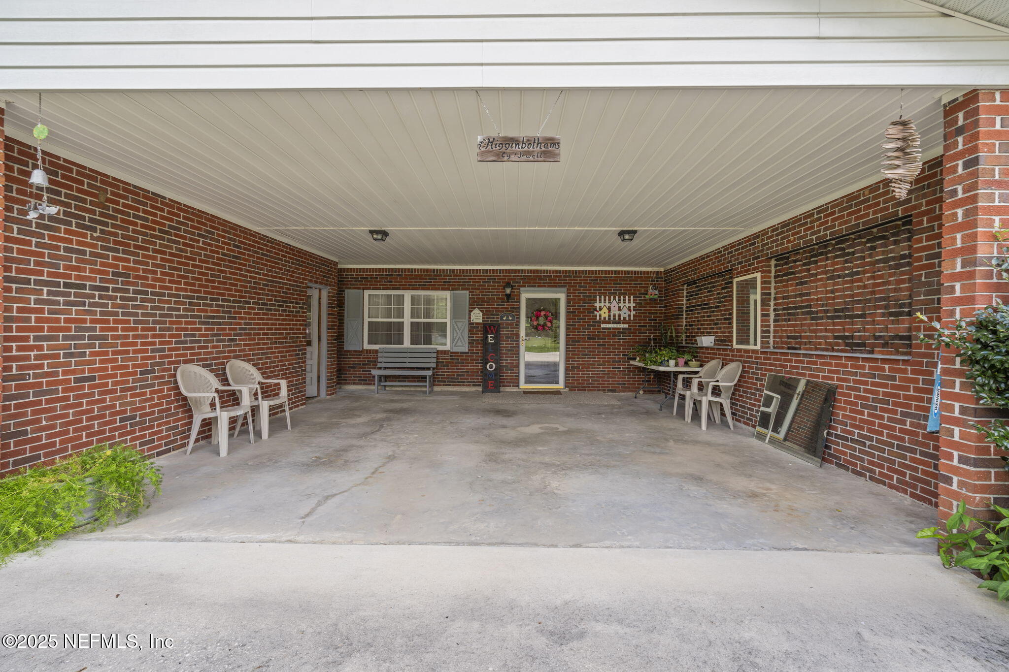 5893 George Hodges Road Macclenny, FL 32063 - Photo 10 of 56 a view of a patio with table and chairs and a barbeque