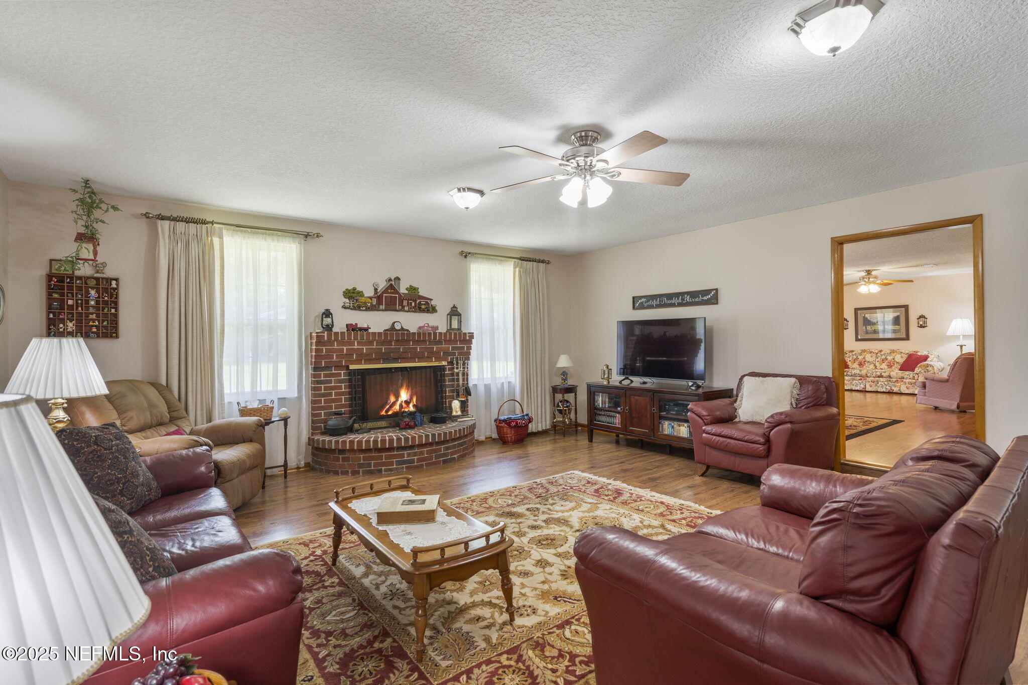 5893 George Hodges Road Macclenny, FL 32063 - Photo 11 of 56 a living room with furniture a fireplace and a flat screen tv
