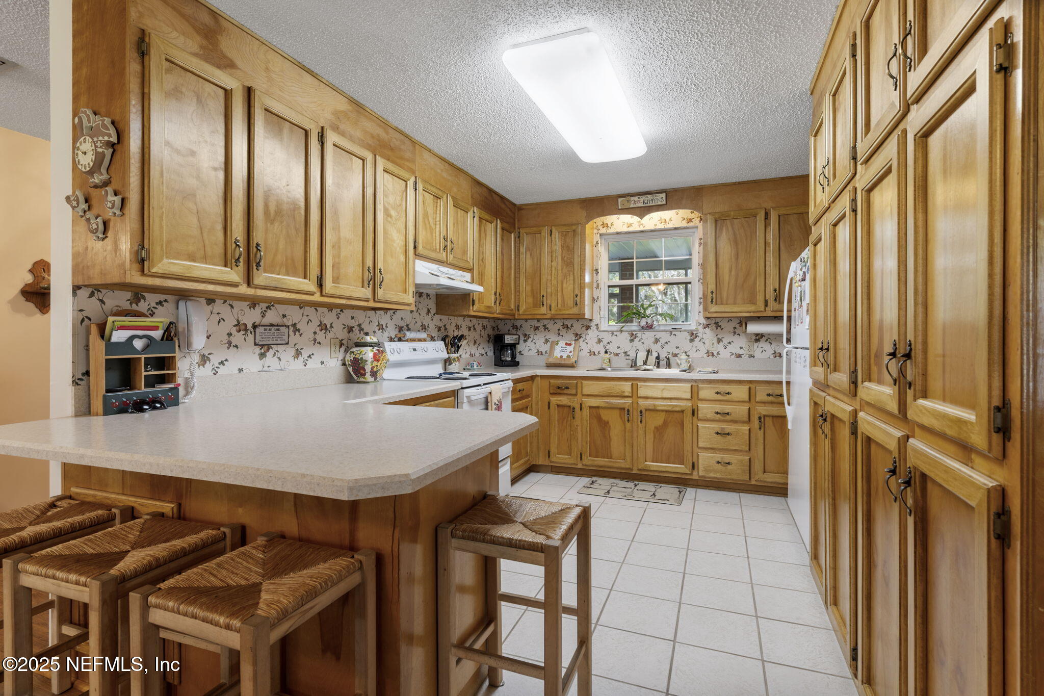 5893 George Hodges Road Macclenny, FL 32063 - Photo 15 of 56 a kitchen with stainless steel appliances granite countertop a sink stove and refrigerator
