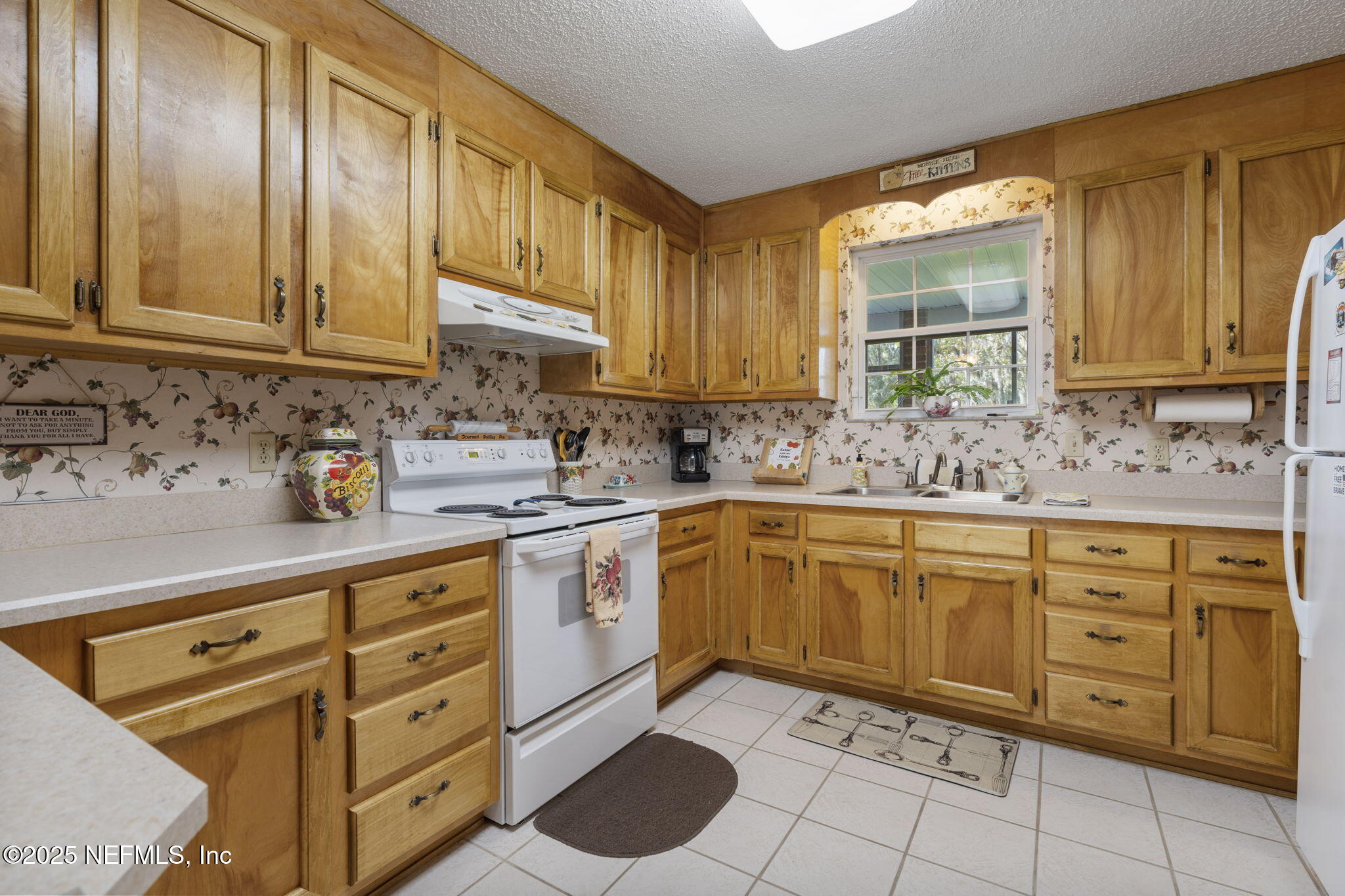 5893 George Hodges Road Macclenny, FL 32063 - Photo 16 of 56 a kitchen with sink cabinets and window