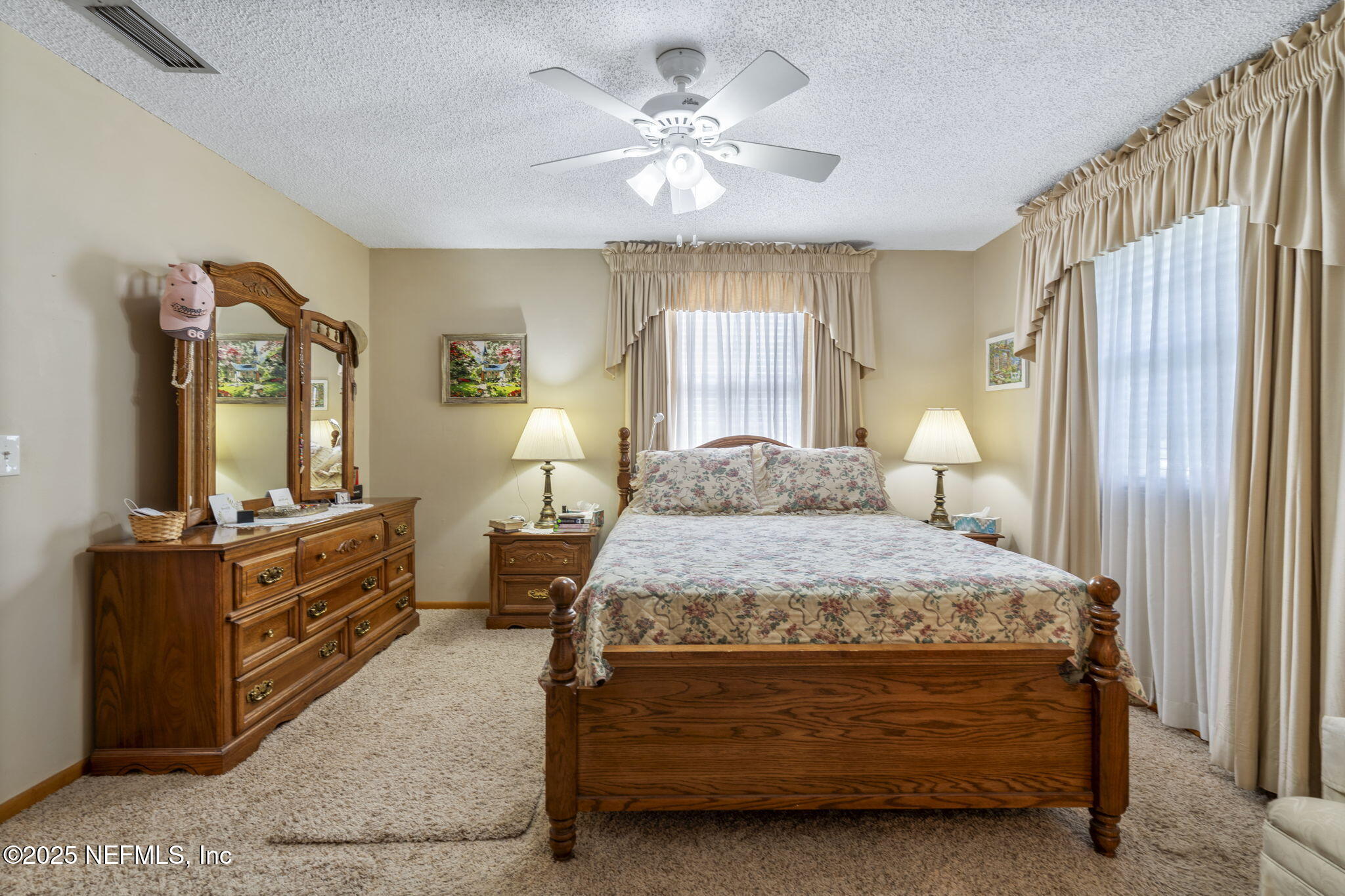 5893 George Hodges Road Macclenny, FL 32063 - Photo 25 of 56 a bedroom with a bed and a chandelier
