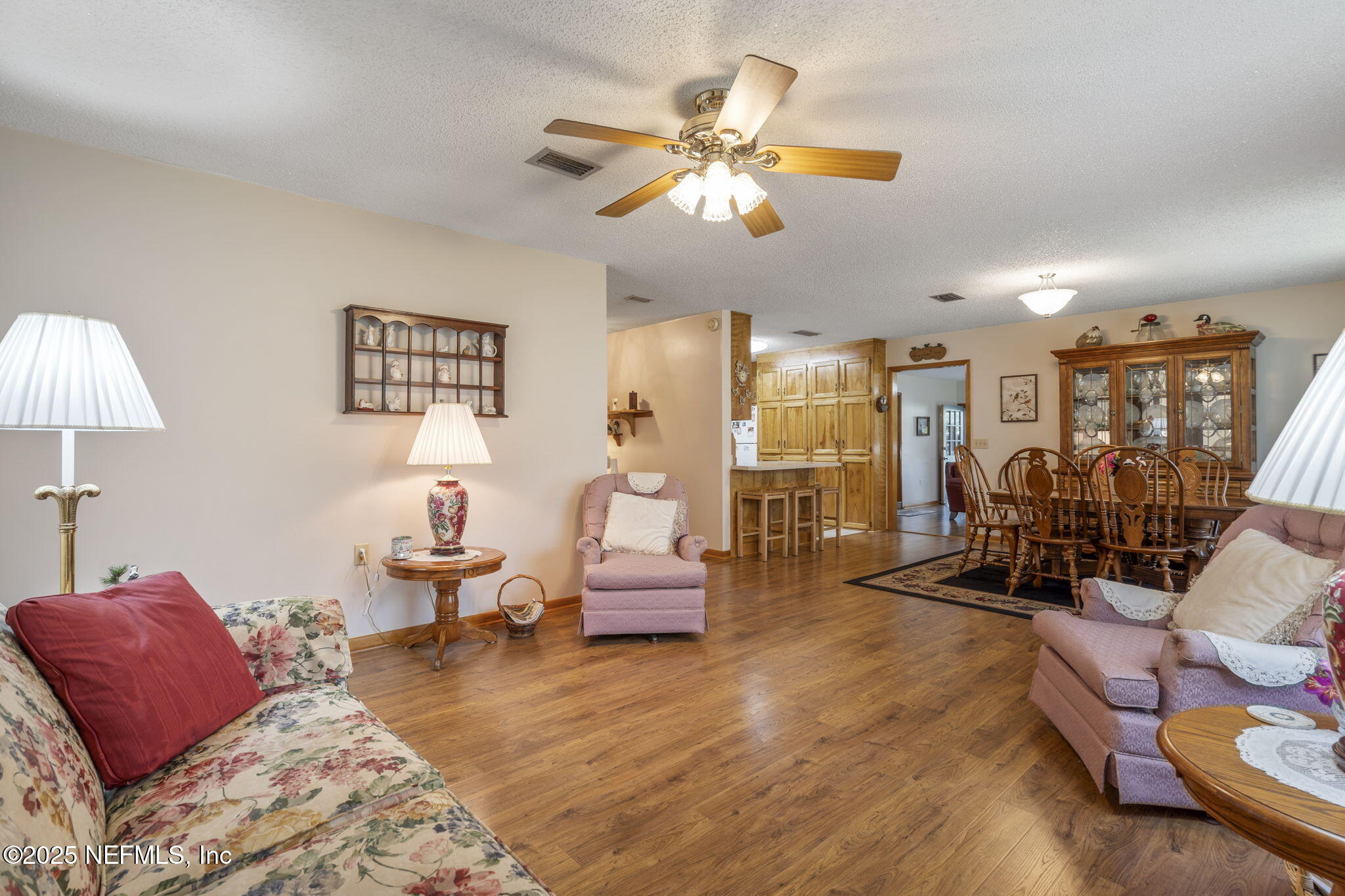 5893 George Hodges Road Macclenny, FL 32063 - Photo 30 of 56 a living room with furniture a chandelier and a flat screen tv