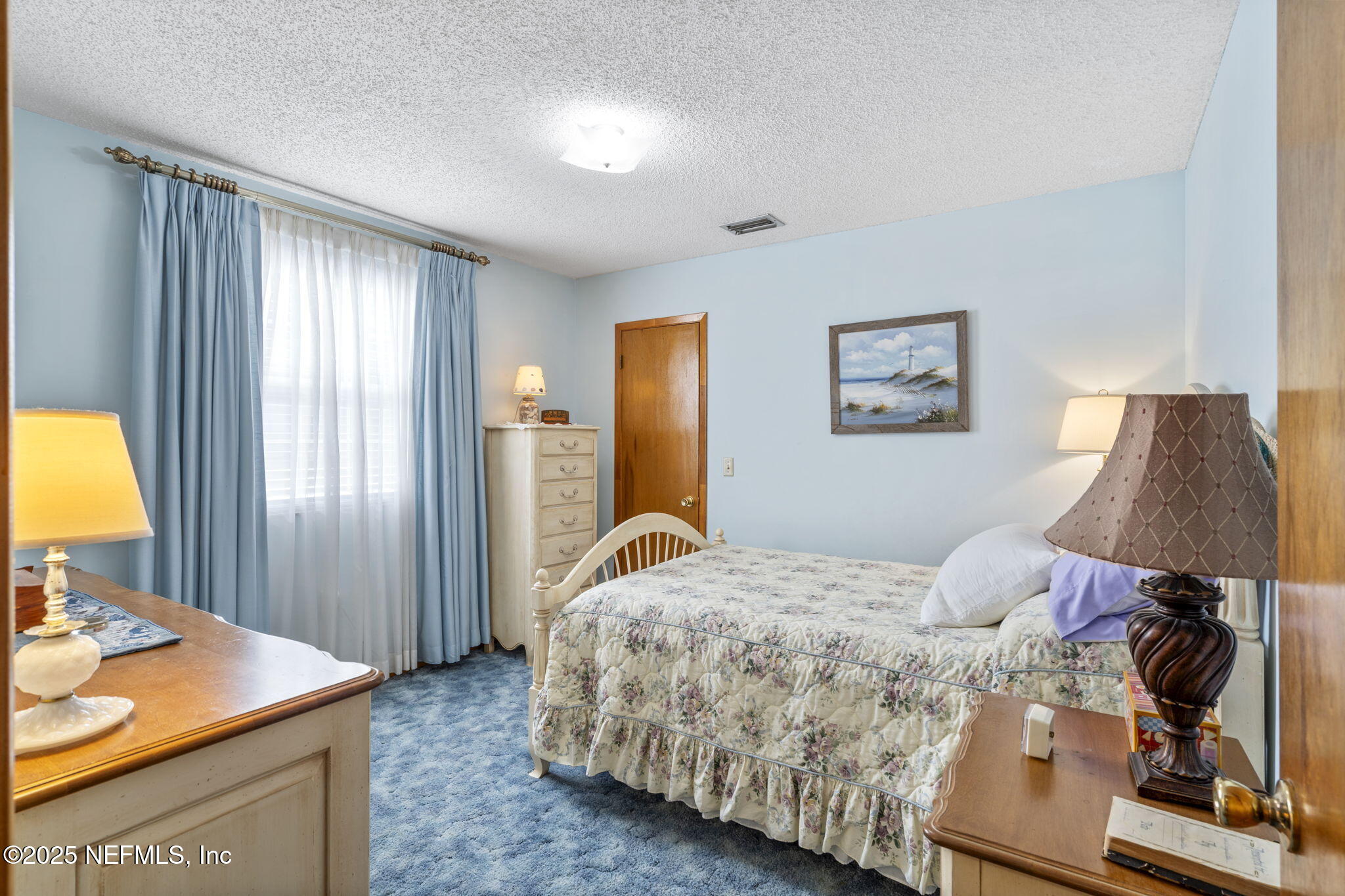 5893 George Hodges Road Macclenny, FL 32063 - Photo 35 of 56 a bedroom with a bed and a table