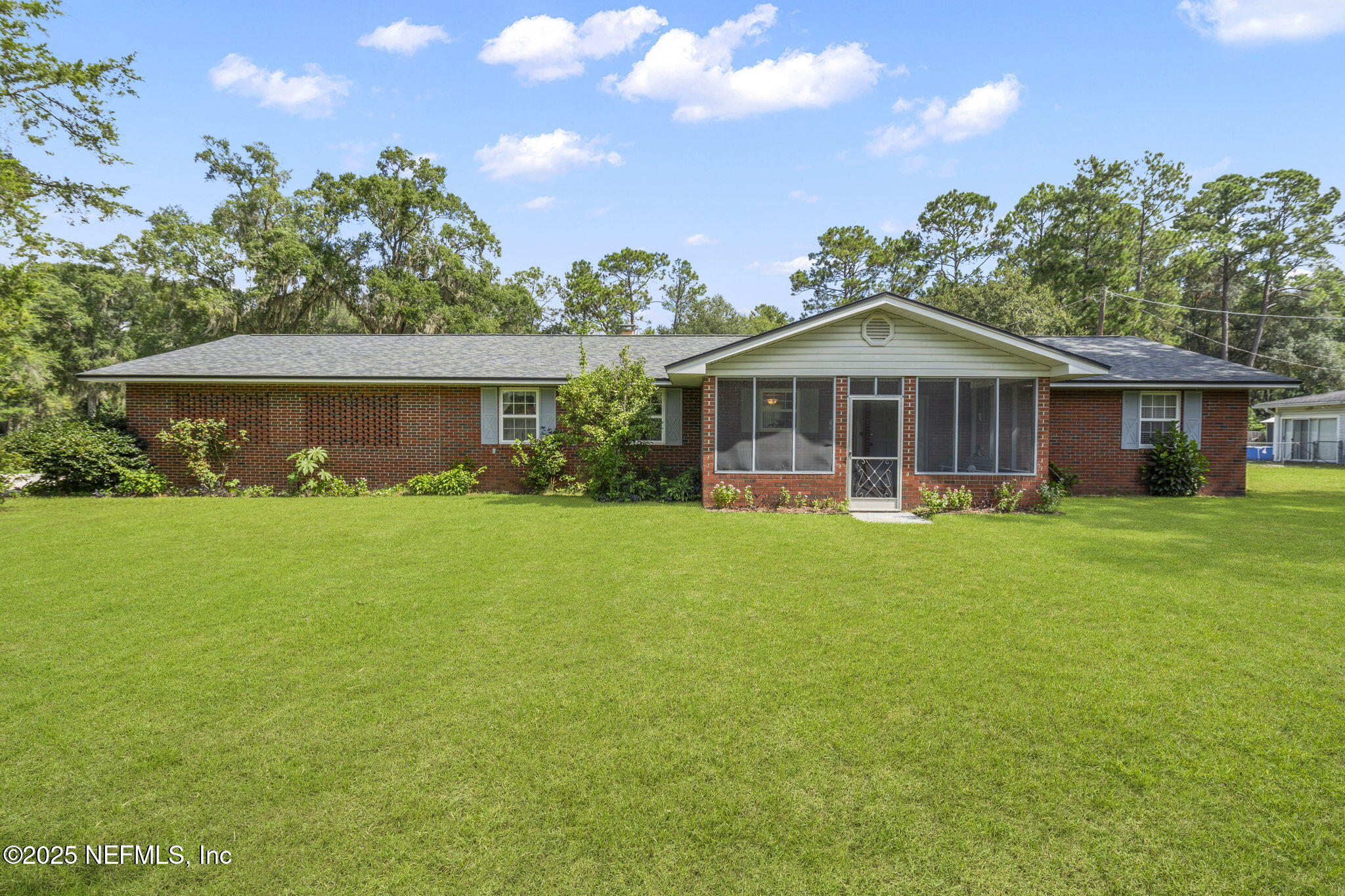 5893 George Hodges Road Macclenny, FL 32063 - Photo 3 of 56 a front view of a house with a garden