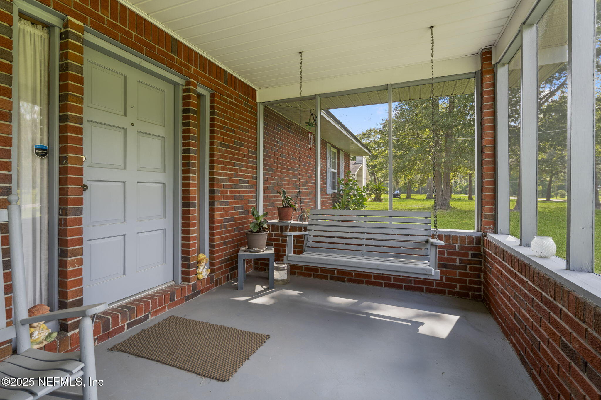 5893 George Hodges Road Macclenny, FL 32063 - Photo 40 of 56 a view of a deck with a floor to ceiling window