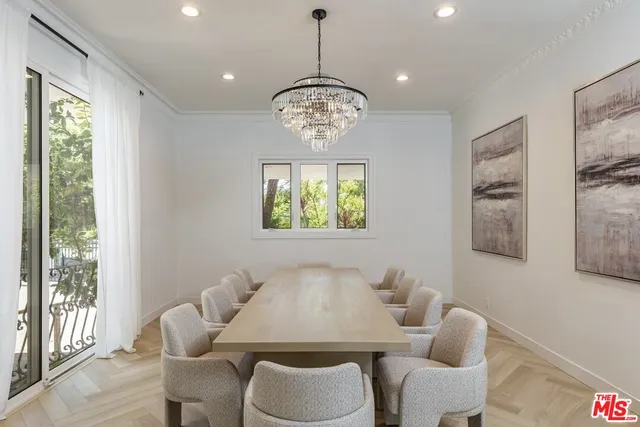 a living room with furniture a window and a chandelier