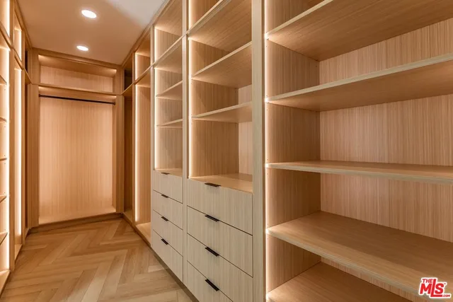 a view of walk in closet with empty racks