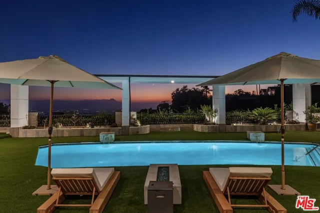 a view of a patio with a table chairs under an umbrella
