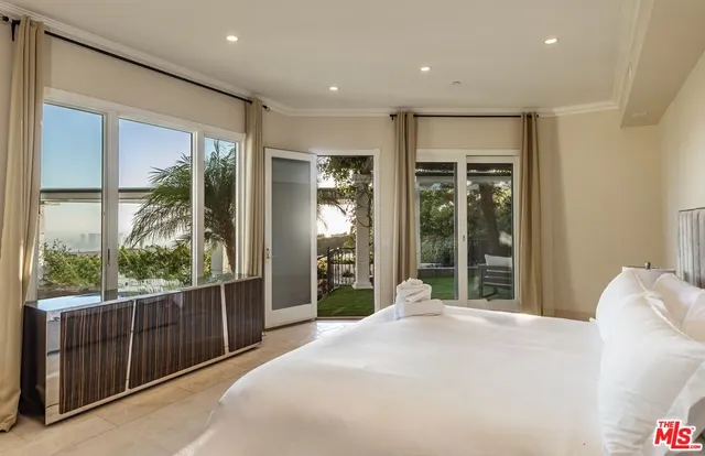 a bedroom with a large bed and a large window