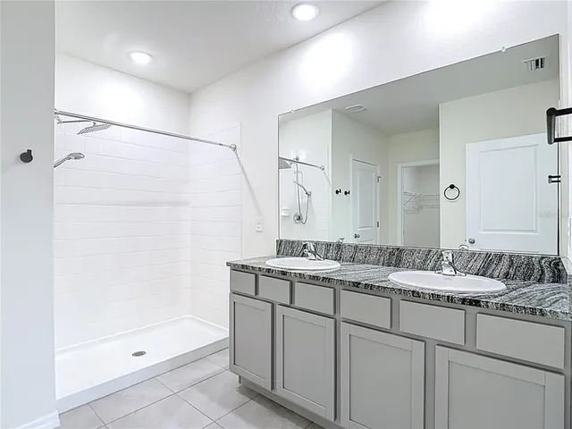 an empty room with closet and fan