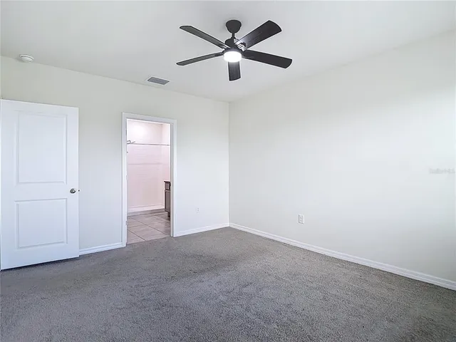 a bathroom with a granite countertop sink toilet a mirror and shower