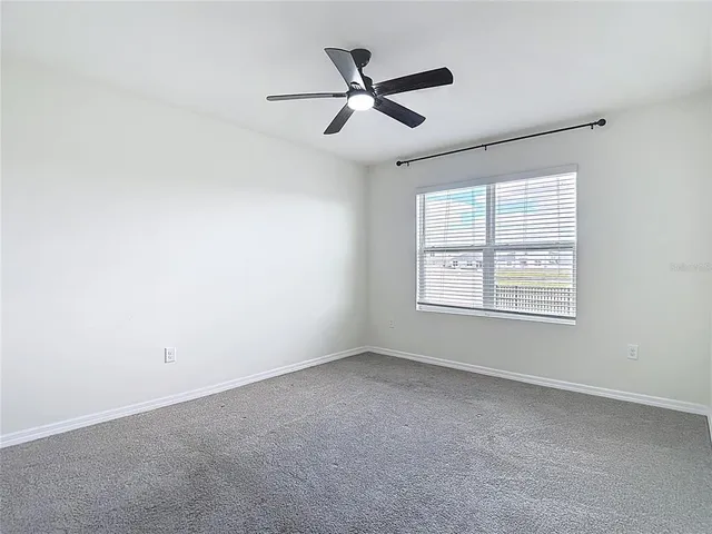 a view of kitchen view with cabinets and refrigerator