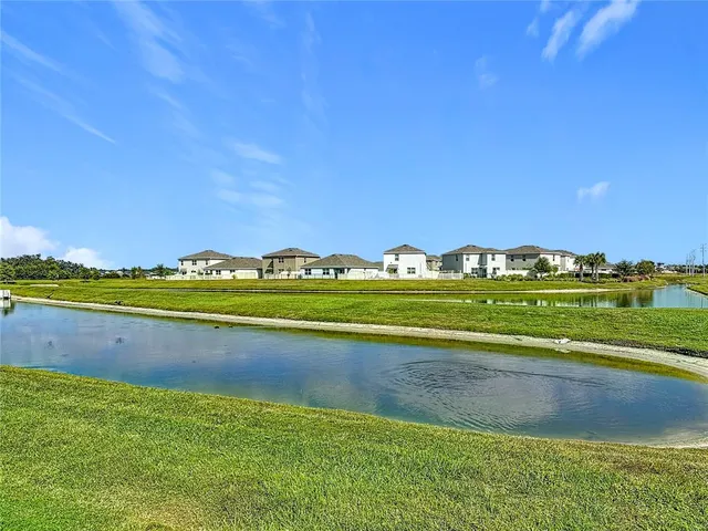a view of a house with backyard and porch