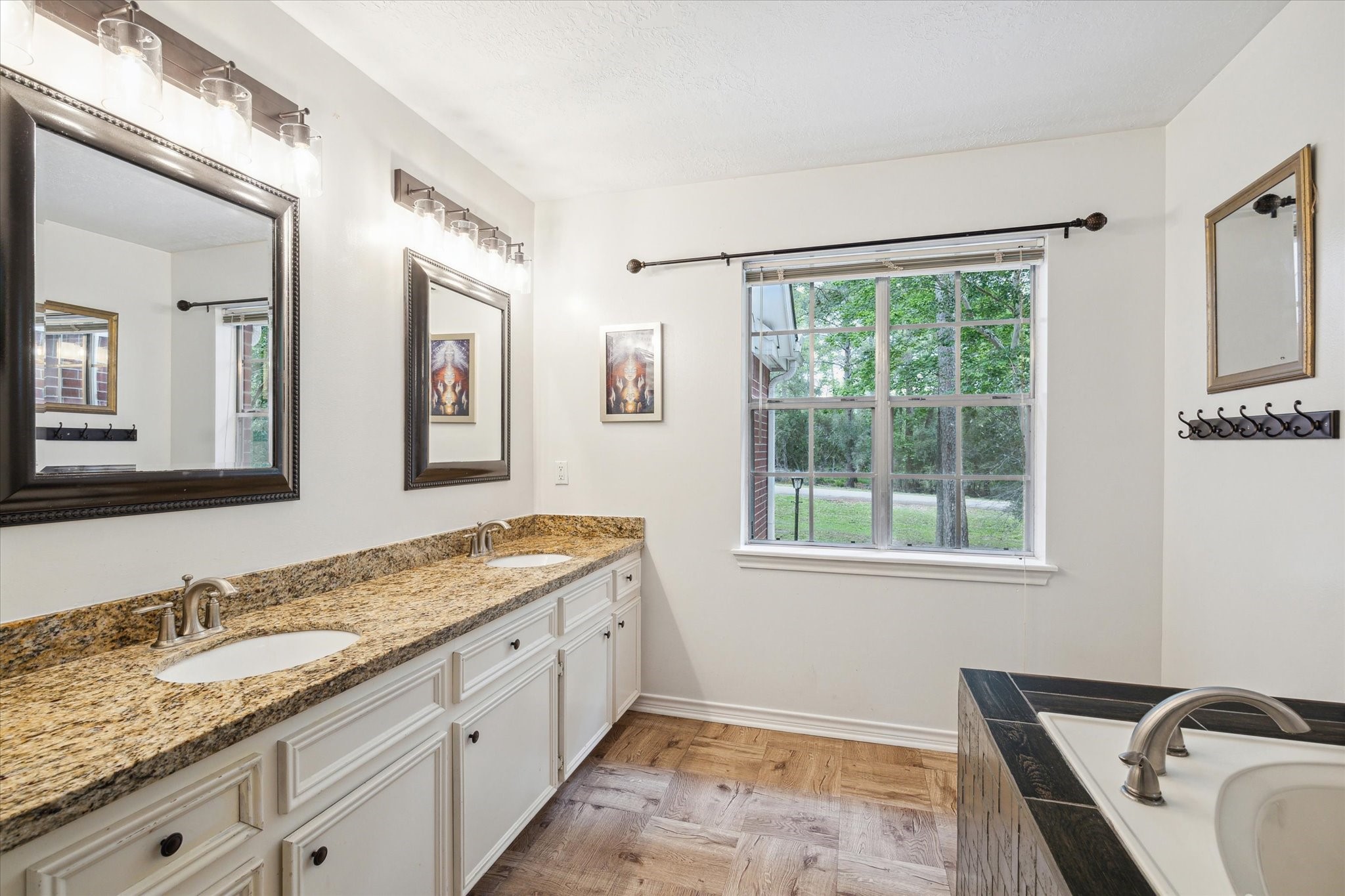 2420 Canter Lane Conroe, TX 77384 - Photo 17 of 24 a bathroom with a granite countertop sink mirror and a window