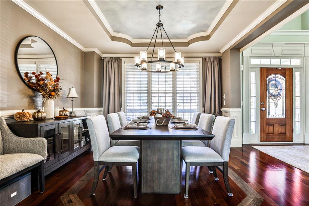 872 Pathview Court Dacula, GA 30019 - Photo 11 of 62 a view of a dining room with furniture wooden floor and chandelier