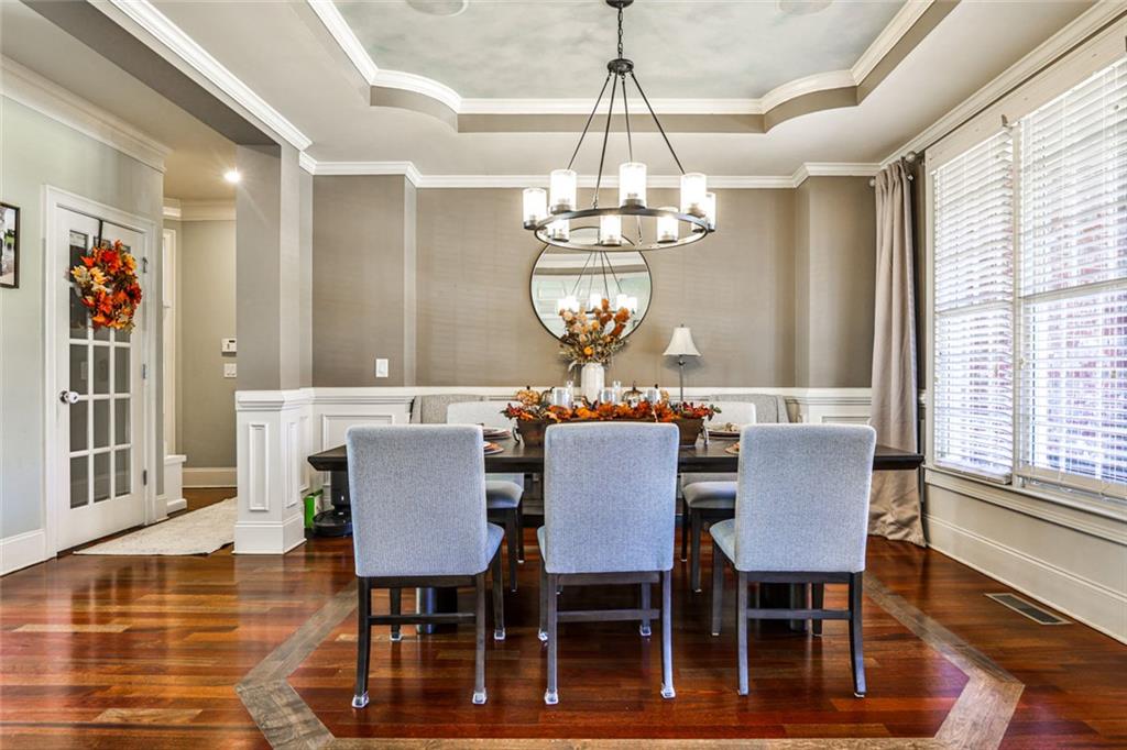 872 Pathview Court Dacula, GA 30019 - Photo 12 of 62 a view of a dining room with furniture a chandelier and wooden floor