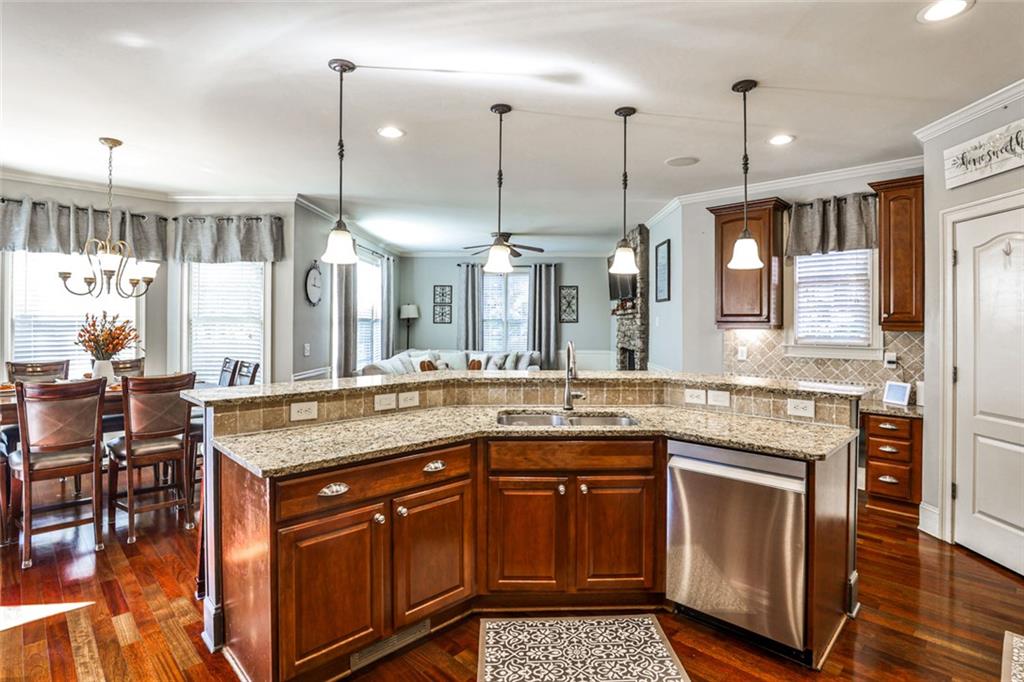 872 Pathview Court Dacula, GA 30019 - Photo 17 of 62 a kitchen with stainless steel appliances granite countertop a stove and a wooden floors