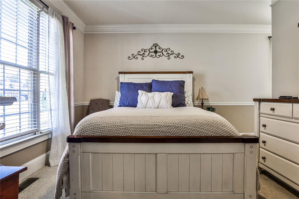 872 Pathview Court Dacula, GA 30019 - Photo 20 of 62 a bedroom with a large bed and a window