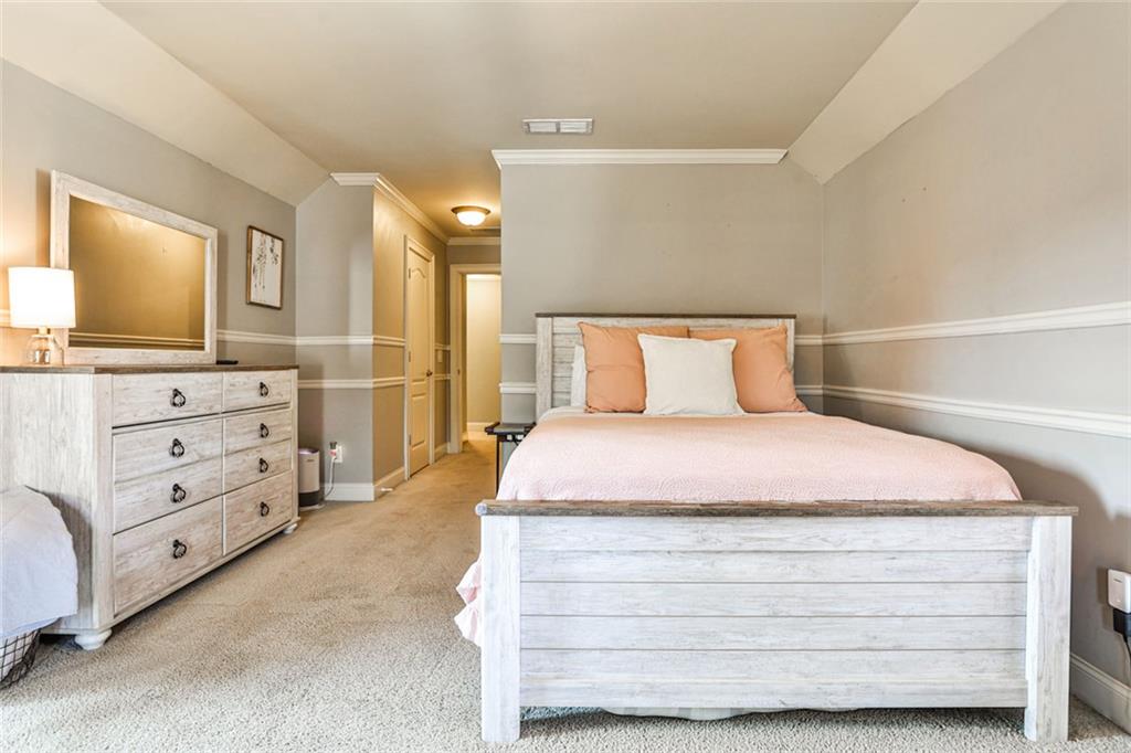 872 Pathview Court Dacula, GA 30019 - Photo 25 of 62 a bedroom with a bed and mirror